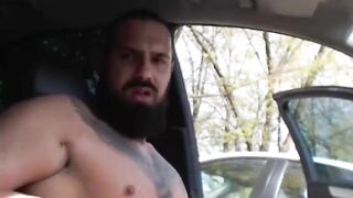 Tattooed muscular guy stroking his cock on public park