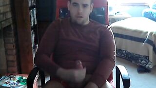 College guy strokes his cock while watching porn