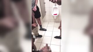 Group of horny guys stroking their cock in public toilet