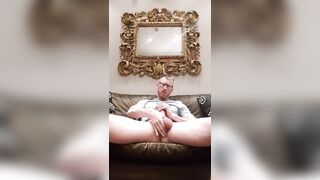 Cute blond dad stroking long cock in the living room