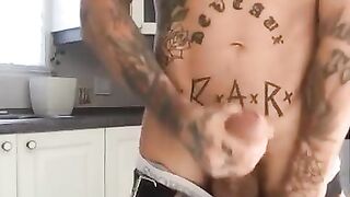 Tattooed latino stroking his cock in the kitchen and shooting a huge load