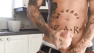 Tattooed latino stroking his cock in the kitchen and shooting a huge load