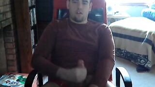 Young college guy strokes his cock while watching porn