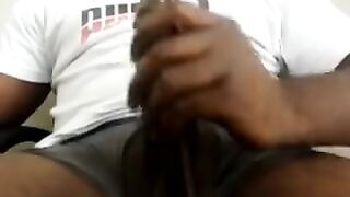 Horny black guy strokes his huge meaty cock
