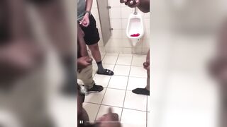 All together jerking off in a public bathroom