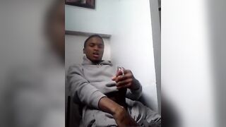 Young black stroking his cock during a work break