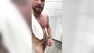 Stud wanking in a public toilet with a happy face