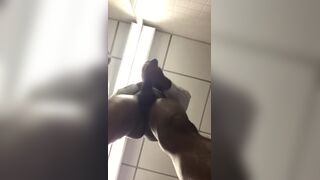 Horny black shows off his huge donkey cock in front of a bathroom mirror