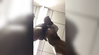 Horny black shows off his huge donkey cock in front of a bathroom mirror