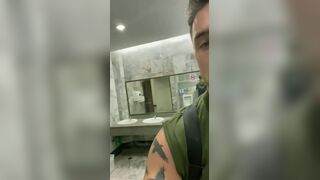 Handsome hung rubbing his cock in a public bathroom
