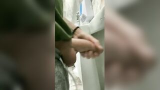 Handsome hung rubbing his cock in a public bathroom
