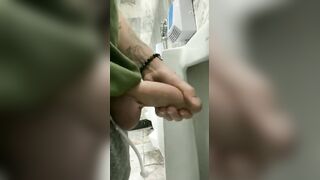 Handsome hung rubbing his cock in a public bathroom
