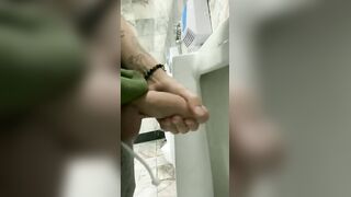 Handsome hung rubbing his cock in a public bathroom