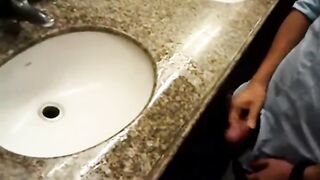 Group of guys rubbing their cock in a public bathroom