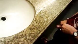 Group of guys rubbing their cock in a public bathroom