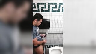 Caught a handsome guy stroking his cock in the toilet