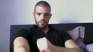 Handsome dude stroking his cock on his bed