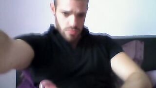 Handsome dude stroking his cock on his bed