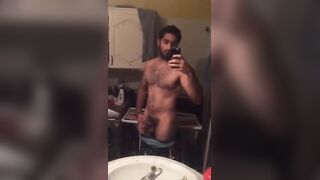 Cute fit arab guy strokes his cock in front of the mirror