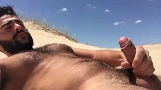 Handsome bearded stud masturbating on the beach