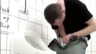 Hung  guy stroking his cock in a public toilet
