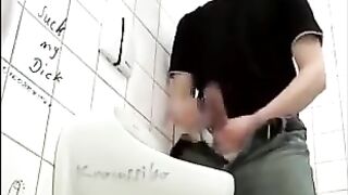 Hung  guy stroking his cock in a public toilet